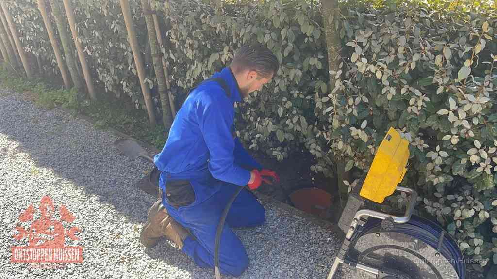 Monteur aan het werk bij een rioolput, de werkwijze voor riool ontstoppen in Huissen